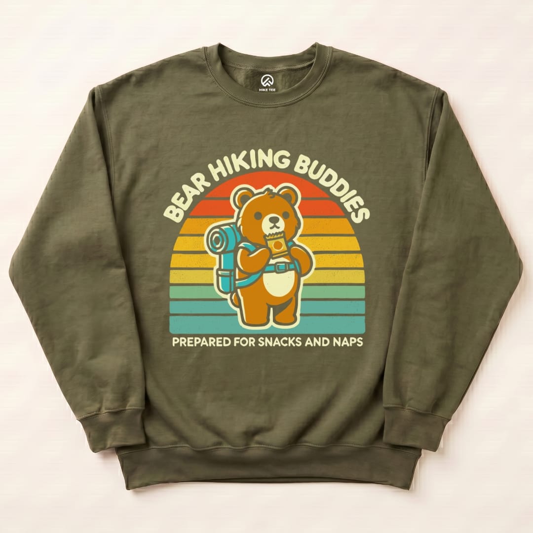The Bear Hiking Buddies Sweatshirt features a cartoon bear with a backpack holding a snack, set against a retro rainbow backdrop.