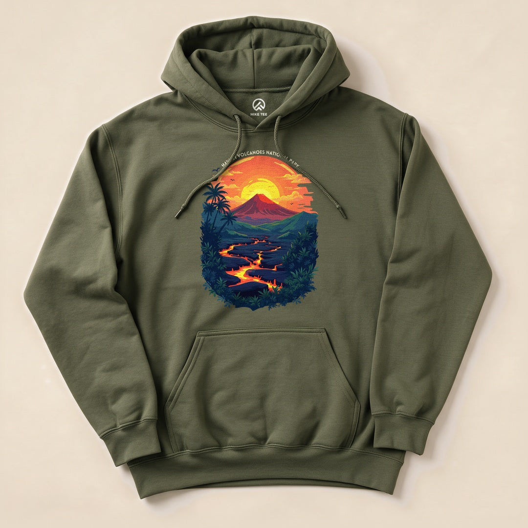 This graphic hoodie features a vibrant sunset scene over Hawai'i Volcanoes National Park, with lush greenery and flowing lava.