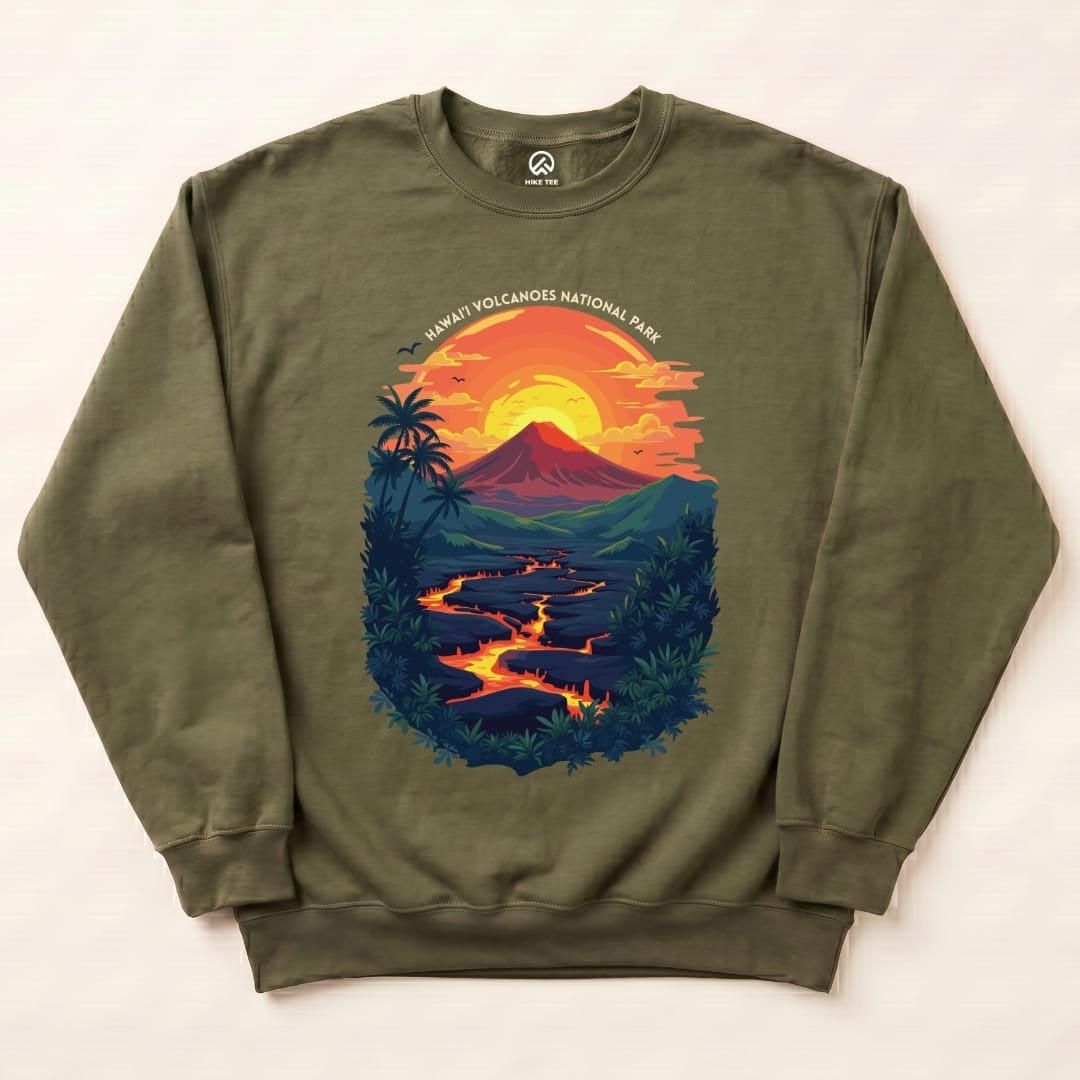 The graphic on the Hawai'i Volcanoes National Park Sweatshirt features a vibrant scene with a volcano, flowing lava, and a sunset backdrop.