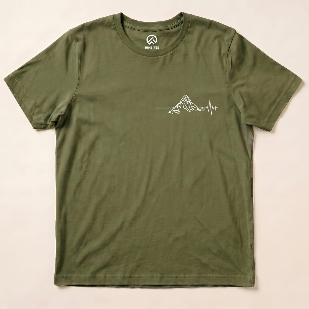 An olive green graphic t-shirt featuring a minimalist mountain outline with a heartbeat line underneath, labeled "Heart Rate Mountain Shirt".