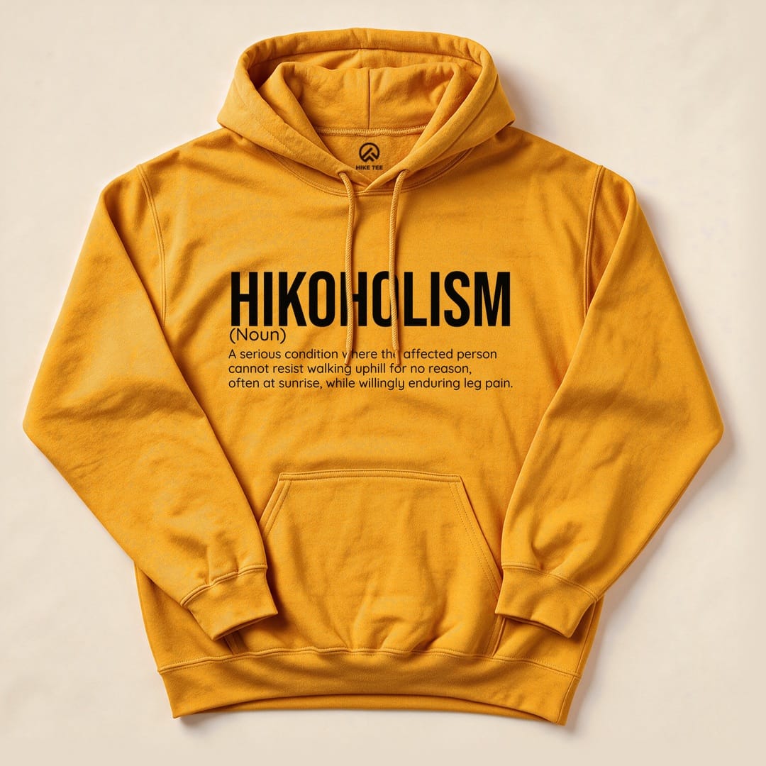 Graphic hoodie in vibrant yellow featuring the text "Hikoholism" and its humorous definition about hiking addiction.