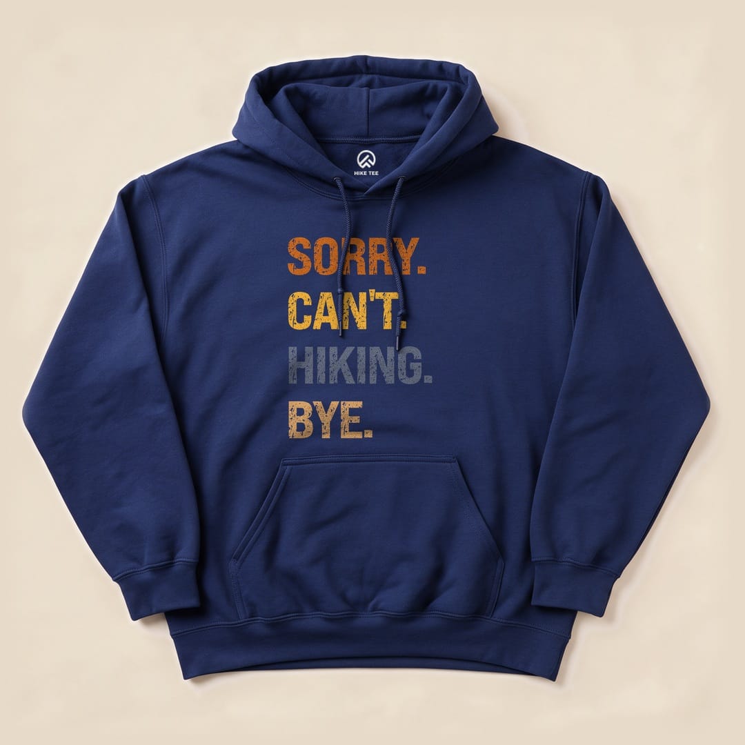 A navy blue hoodie featuring the graphic text "SORRY. CAN'T. HIKING. BYE." in a bold, colorful design.