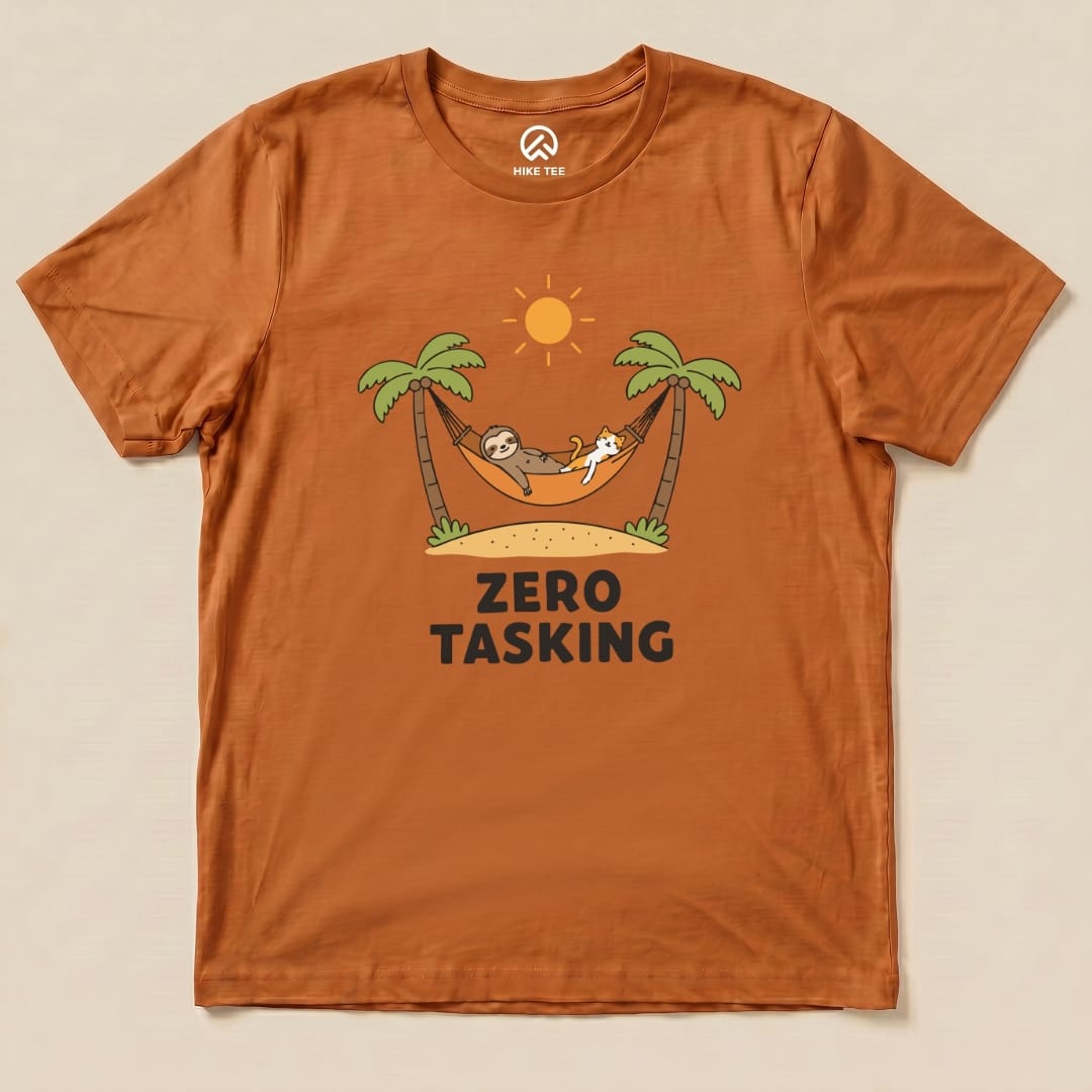 An orange graphic t-shirt features a sloth and a cat lounging in a hammock with the phrase "ZERO TASKING" displayed below.