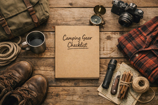 Camping gear checklist notebook surrounded by essential camping equipment on a wooden table