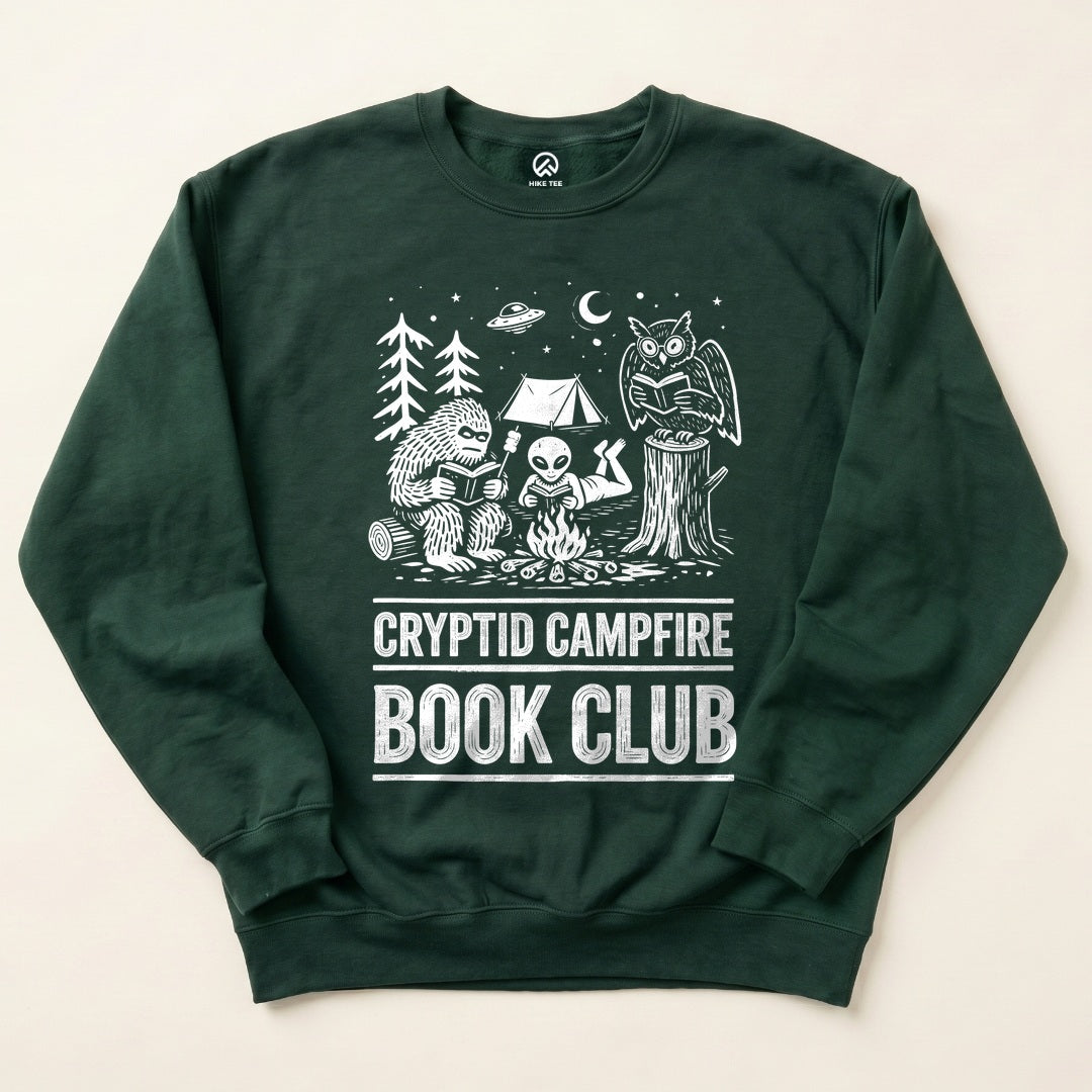 Forest Green Cryptid Campfire Book Club Sweatshirt with a Bigfoot and friends reading around a campfire graphic