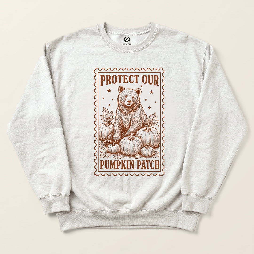 Ash Protect Our Pumpkin Patch Sweatshirt with a vintage-style bear among pumpkins in a stamp frame graphic