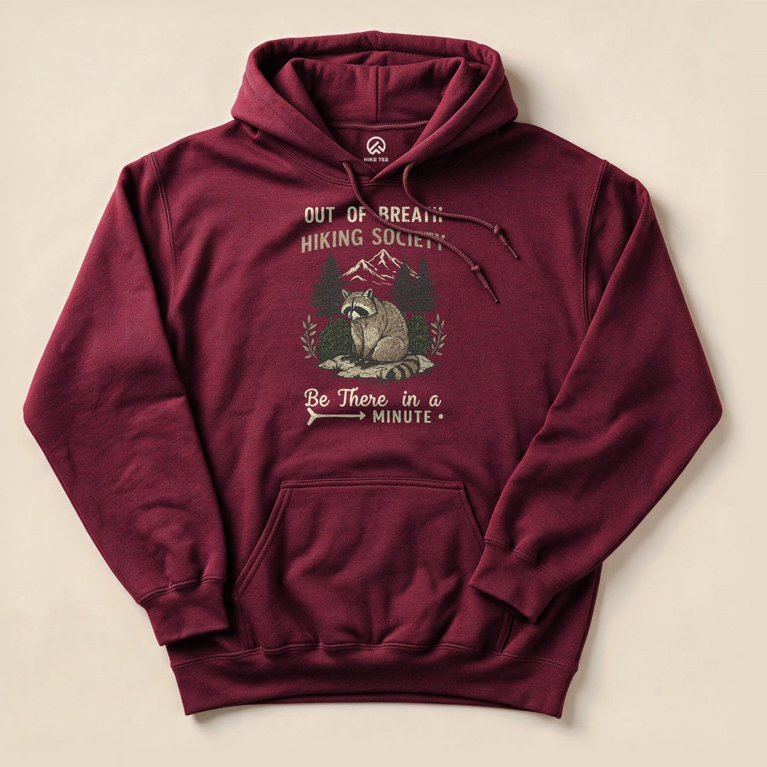Maroon Out of Breath Hiking Society Raccoon Hoodie with a funny raccoon hiking graphic