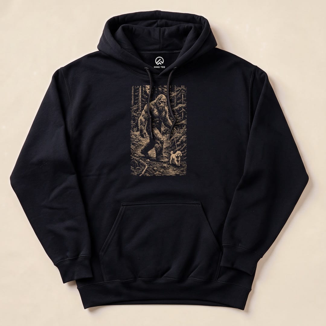A graphic "Walking the Dog Hoodie" features a whimsical illustration of Bigfoot walking a small dog in a forest setting.
