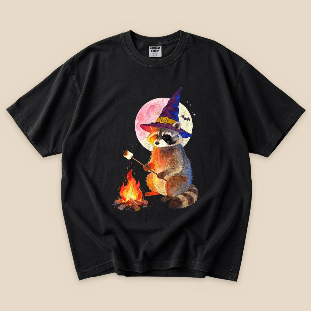 Black Raccoon Witch Campfire T-Shirt with a raccoon witch at a campfire graphic