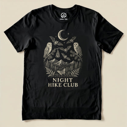 Black Night Hike Club Engraved Shirt with a night forest scene with a moon, owls, moths and mountains in engraved style graphic