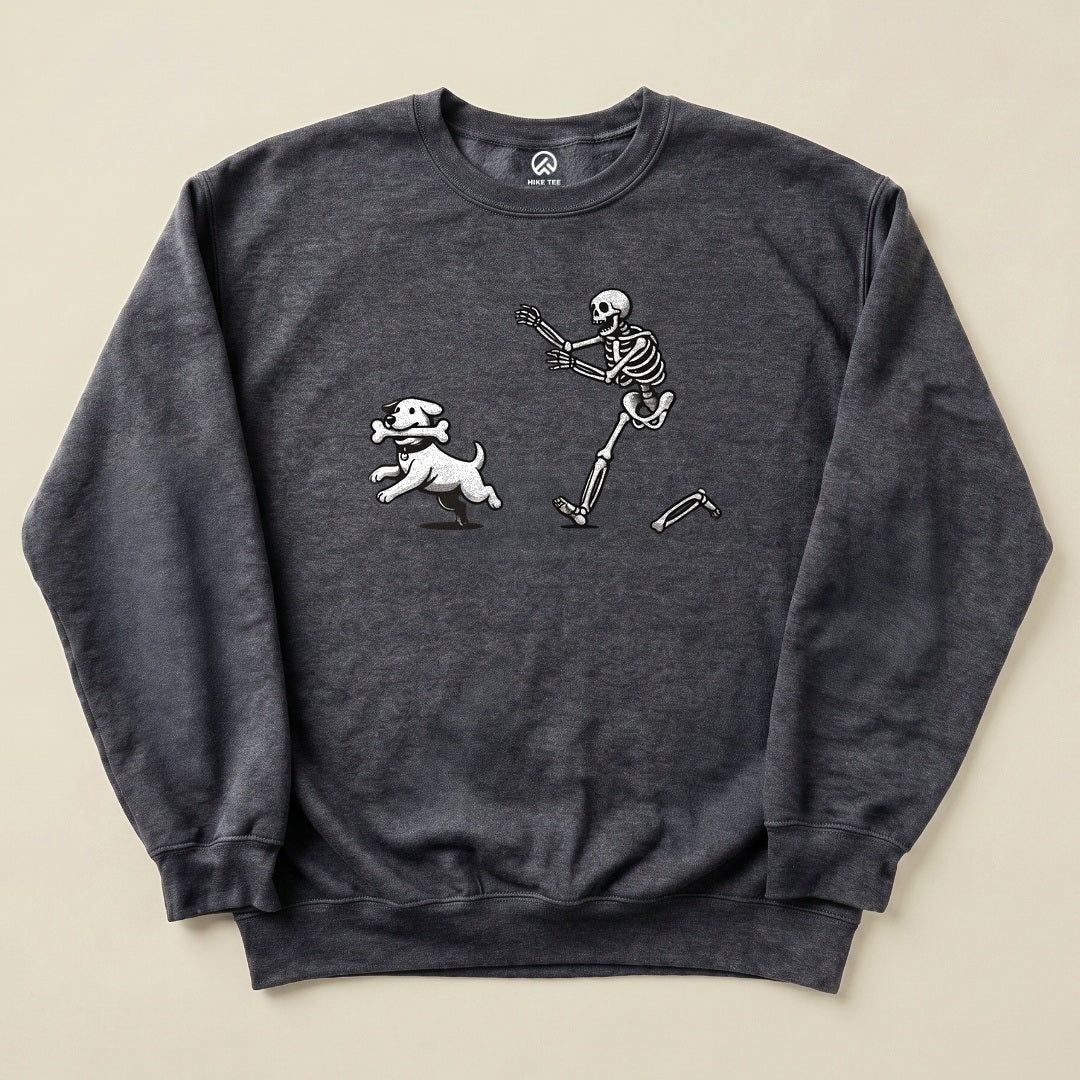 Graphic t-shirt featuring a playful skeleton running alongside a white dog, titled "Skeleton and Dog Sweatshirt" on a charcoal background.