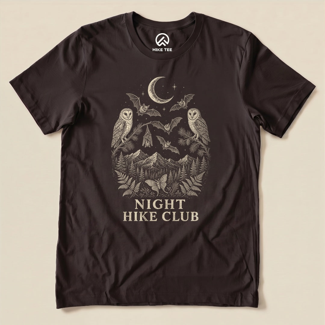 Brown Night Hike Club Engraved Shirt with a night forest scene with a moon, owls, moths and mountains in engraved style graphic