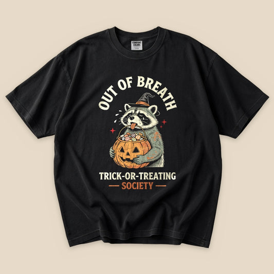 Black Out of Breath Trick-or-Treating Society T-Shirt with a raccoon with a jack-o'-lantern trick-or-treating graphic