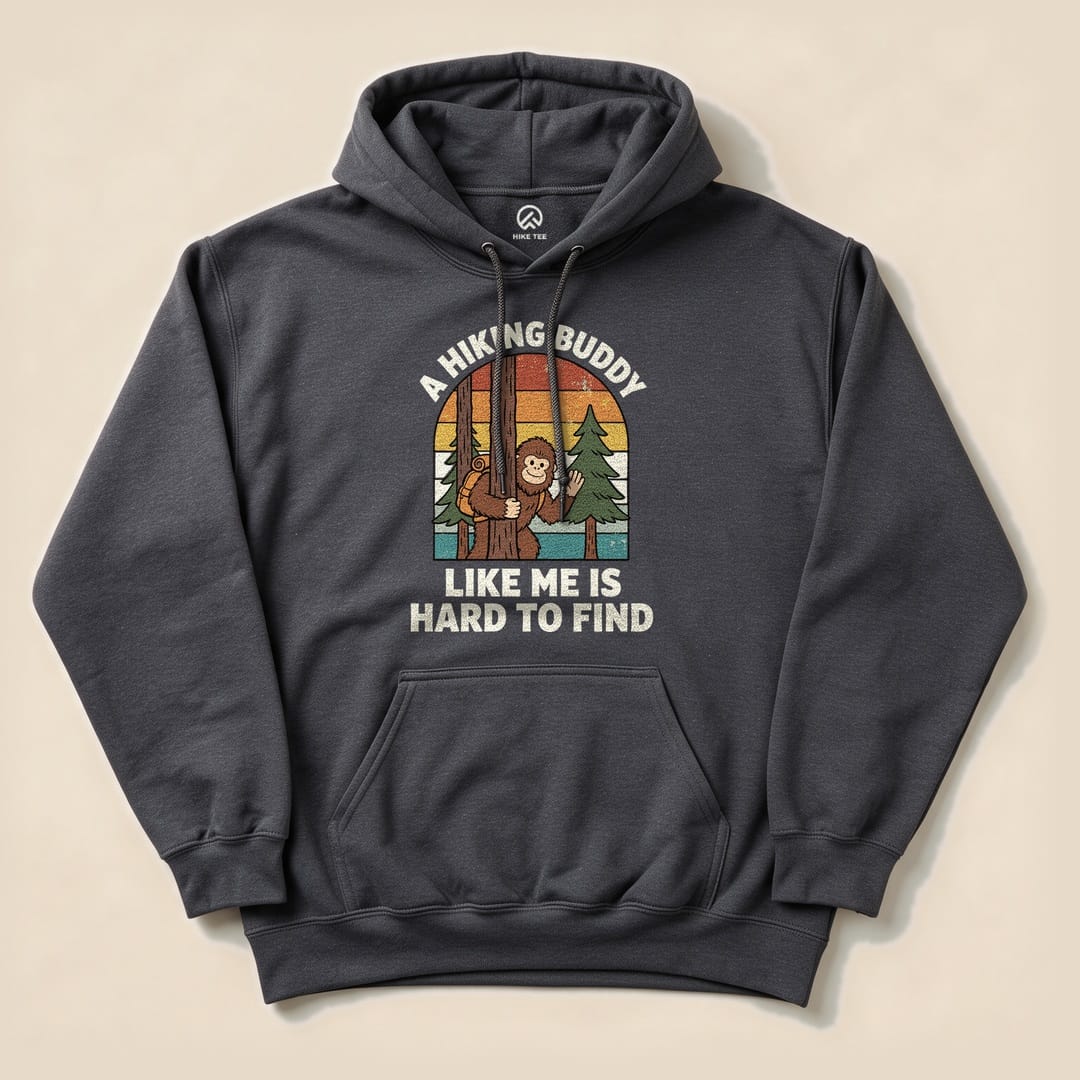 A gray hoodie featuring a graphic of a monkey hanging from a tree, with the text "A Hiking Buddy Like Me Is Hard To Find".