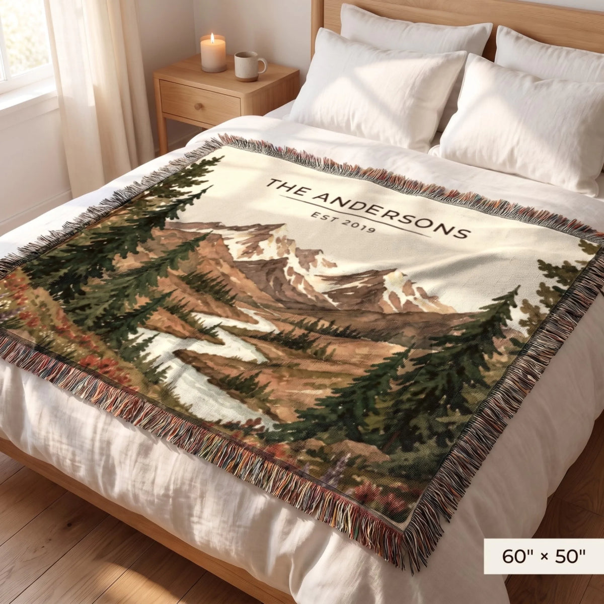Mountain River Wildflower Woven Blanket 60x50 on a queen bed with personalized family name