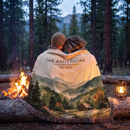 Couple wrapped in the personalized Great Smoky Mountains Cabin Woven Blanket by a campfire