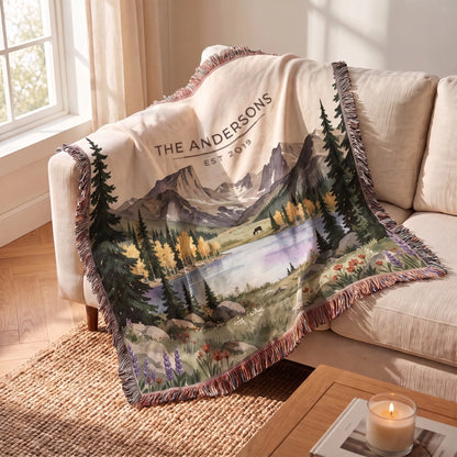 Rocky Mountain Lake Elk Woven Blanket draped over a sofa
