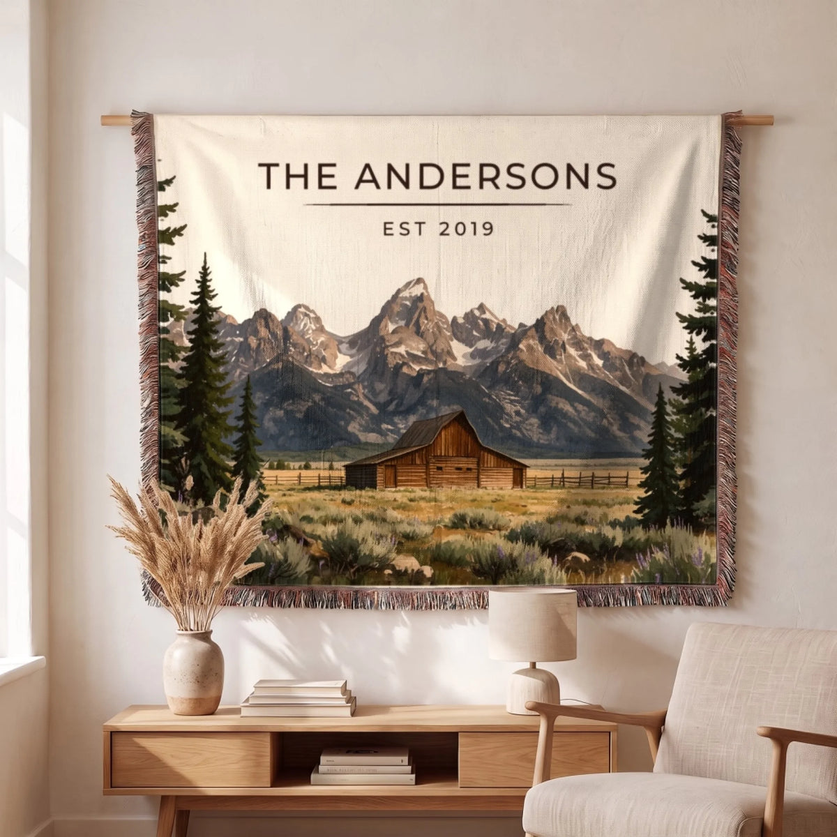 Personalized Grand Teton Barn Woven Blanket hanging on a wall, family name woven in