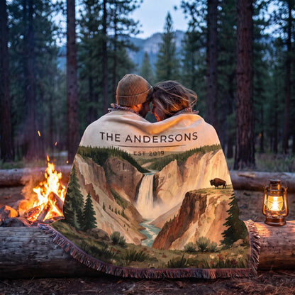 Couple wrapped in the Yellowstone Falls Bison Woven Blanket by a campfire