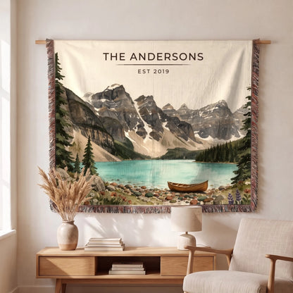 Personalized Glacier Lake Canoe Woven Blanket hanging on a wall, family name woven in