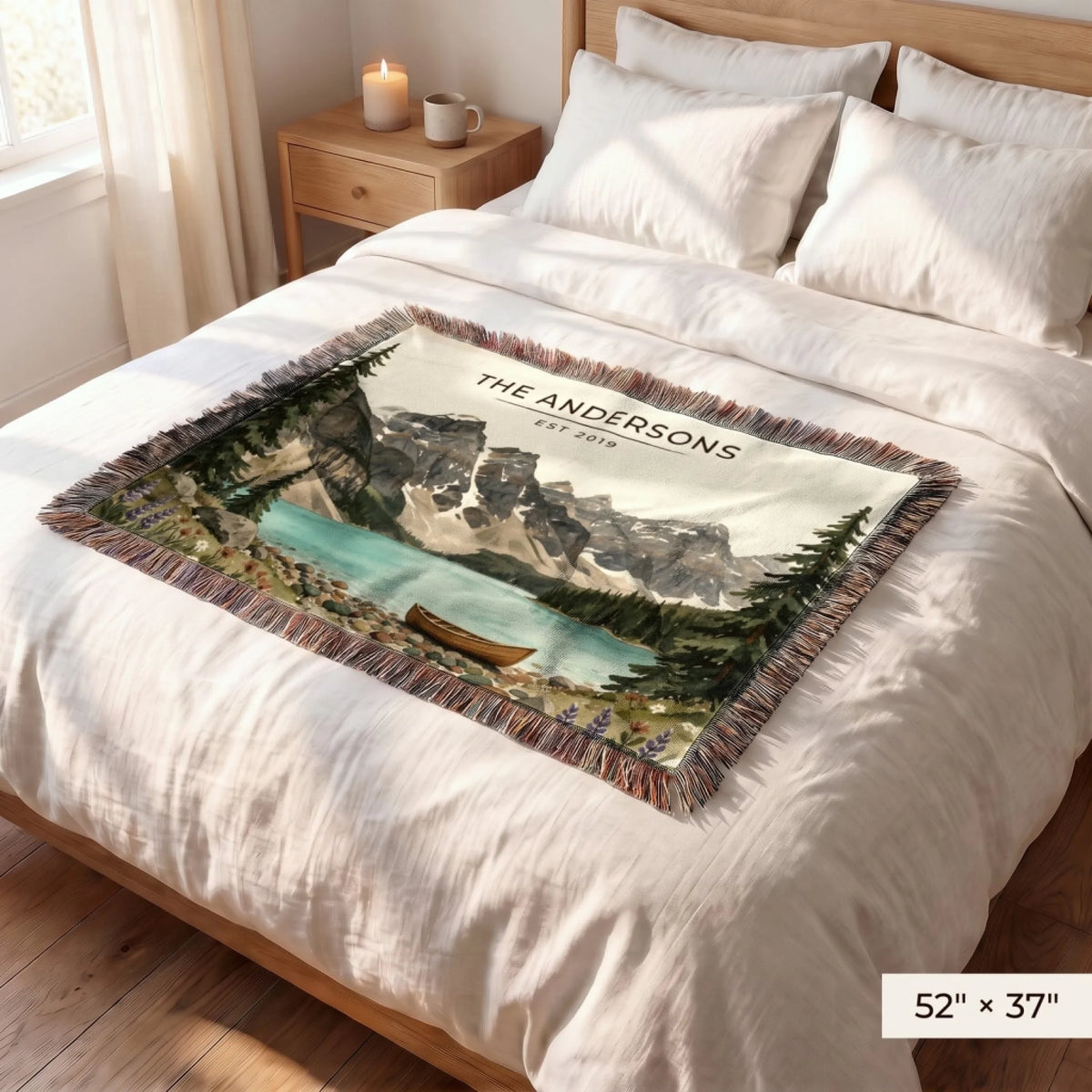 Glacier Lake Canoe Woven Blanket 52x37 on a queen bed