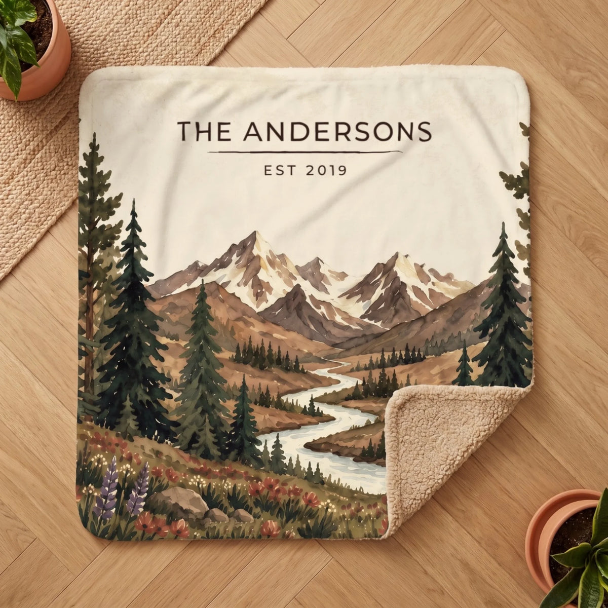Personalized Mountain River Wildflower Sherpa Blanket on a wooden floor with the cozy sherpa back showing