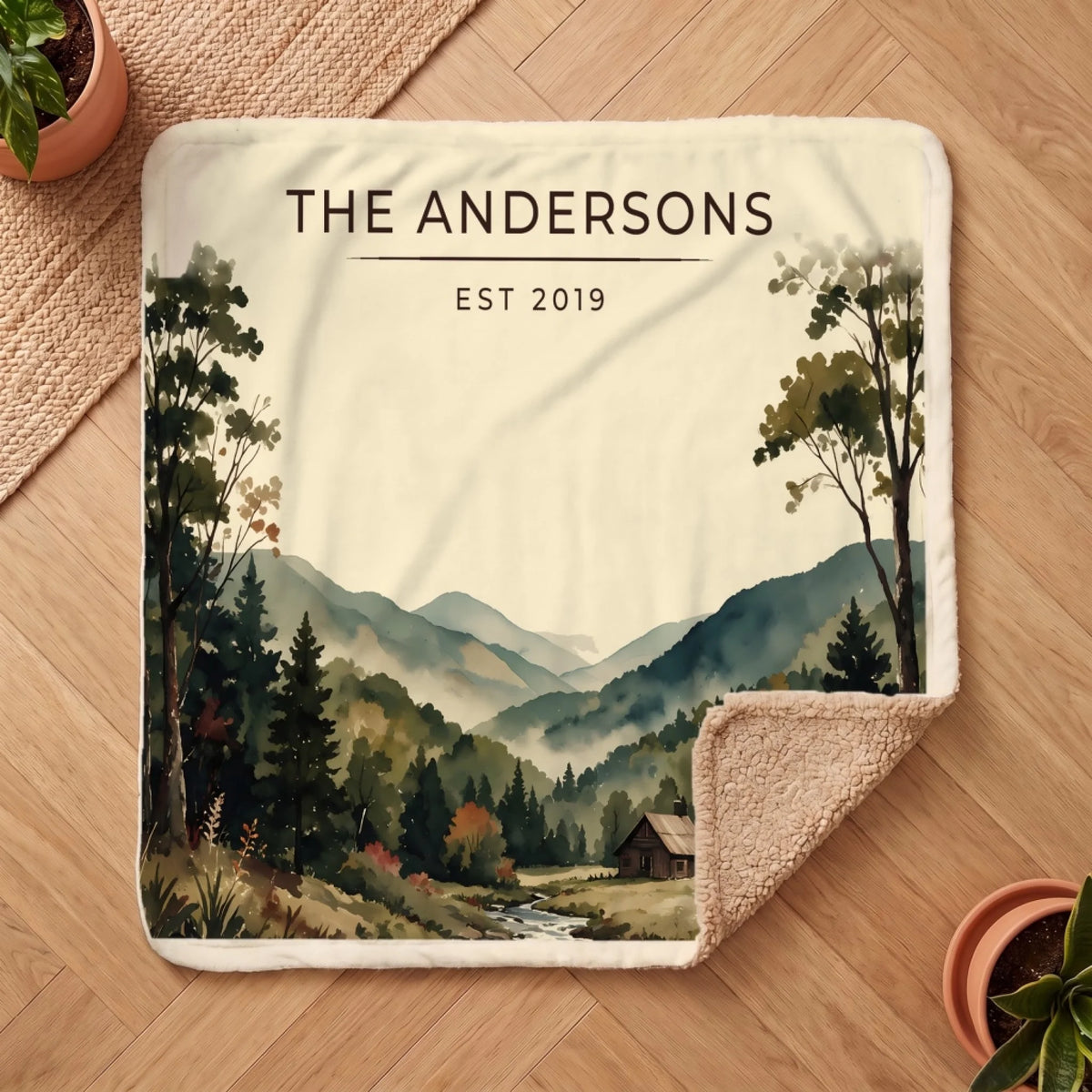 Personalized Great Smoky Mountains Cabin Sherpa Blanket on a wooden floor with the cozy sherpa back showing