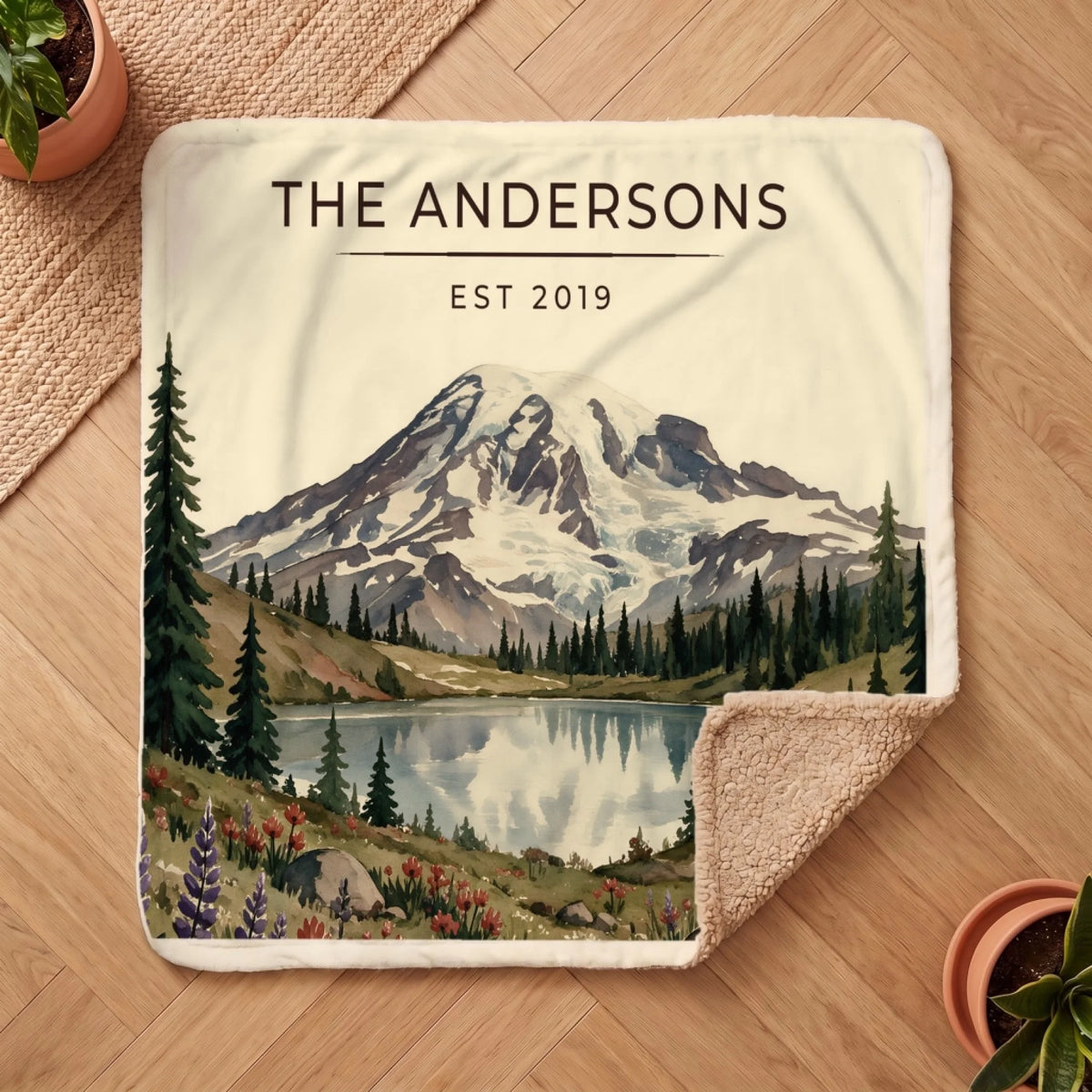 Personalized Mount Rainier Lake Sherpa Blanket on a wooden floor with the cozy sherpa back showing