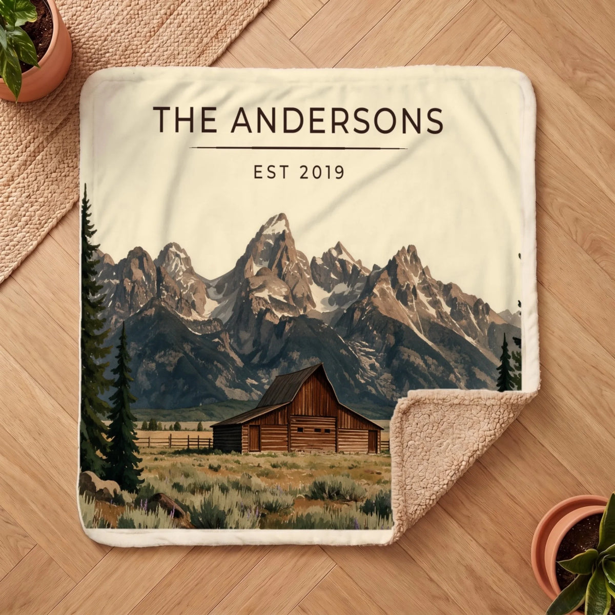 Personalized Grand Teton Barn Sherpa Blanket on a wooden floor with the cozy sherpa back showing