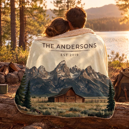Couple wrapped in the Grand Teton Barn Sherpa Blanket by a lake