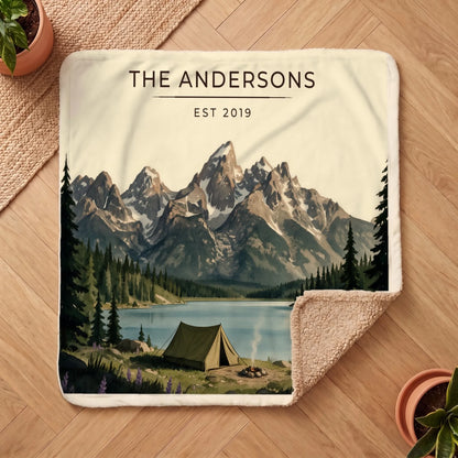 Personalized Grand Teton Lake Campsite Sherpa Blanket on a wooden floor with the cozy sherpa back showing