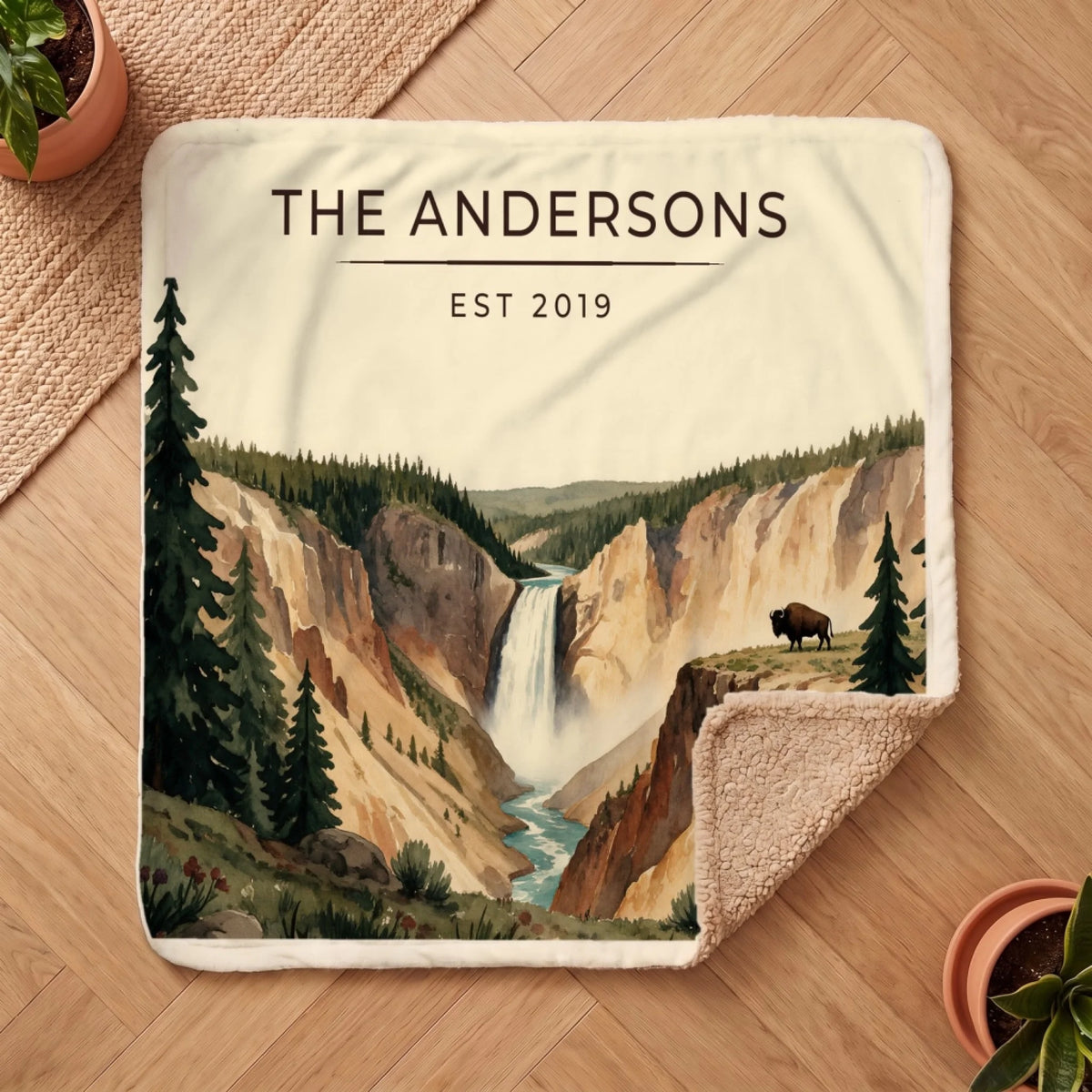 Personalized Yellowstone Falls Bison Sherpa Blanket on a wooden floor with the cozy sherpa back showing