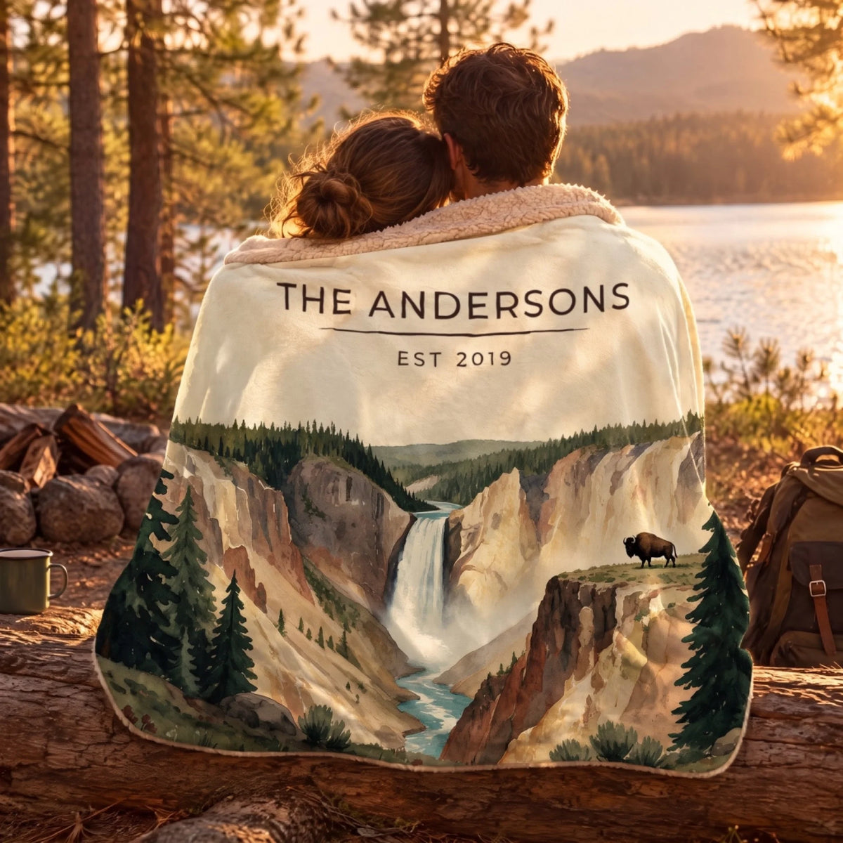 Couple wrapped in the Yellowstone Falls Bison Sherpa Blanket by a lake