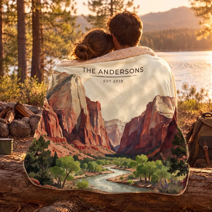 Couple wrapped in the Zion Canyon River Sherpa Blanket by a lake