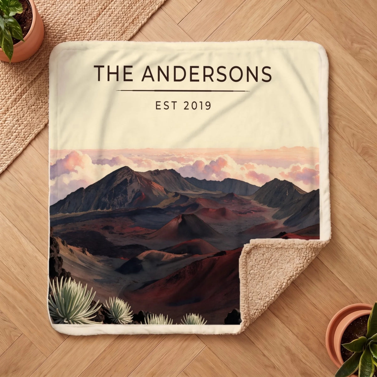 Personalized Haleakala Crater Sunrise Sherpa Blanket on a wooden floor with the cozy sherpa back showing