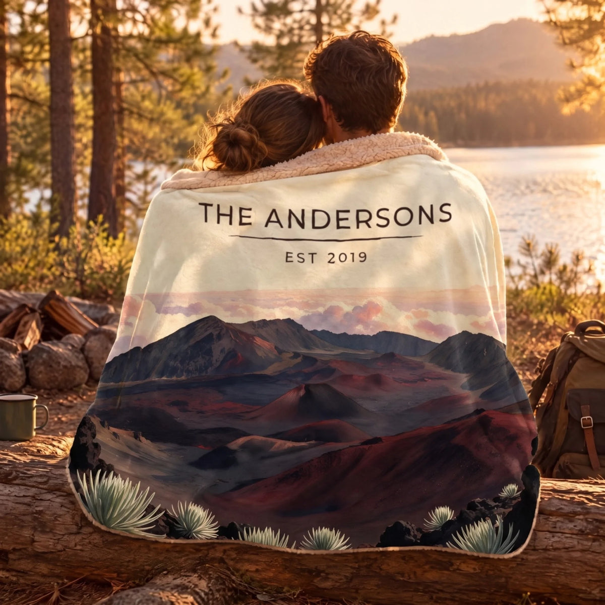 Couple wrapped in the Haleakala Crater Sunrise Sherpa Blanket by a lake