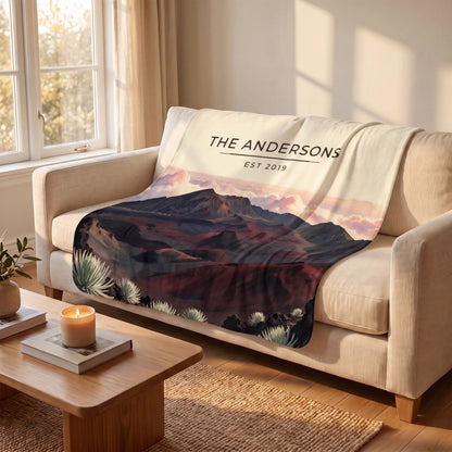Haleakala Crater Sunrise Sherpa Blanket draped over a sofa