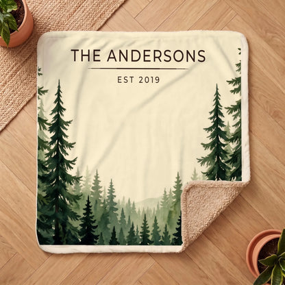 Personalized Evergreen Forest Treetops Sherpa Blanket on a wooden floor with the cozy sherpa back showing