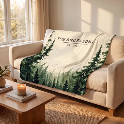 Evergreen Forest Treetops Sherpa Blanket draped over a sofa