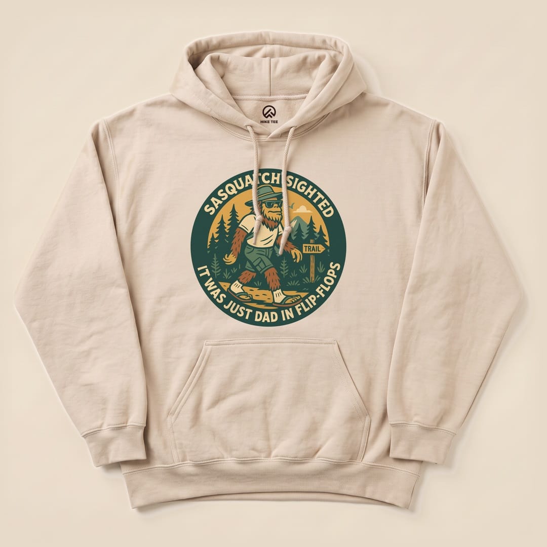 A beige "Sasquatch Sighted Hoodie" features a playful graphic of Sasquatch walking in flip-flops among trees.
