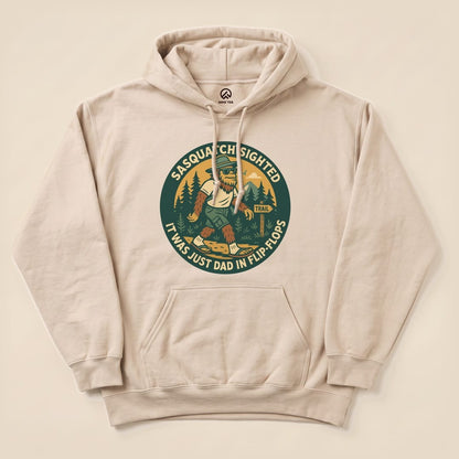 A beige "Sasquatch Sighted Hoodie" features a playful graphic of Sasquatch walking in flip-flops among trees.