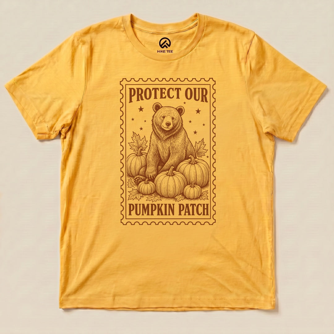 Gold Protect Our Pumpkin Patch Shirt with a bear among pumpkins in a vintage stamp frame graphic