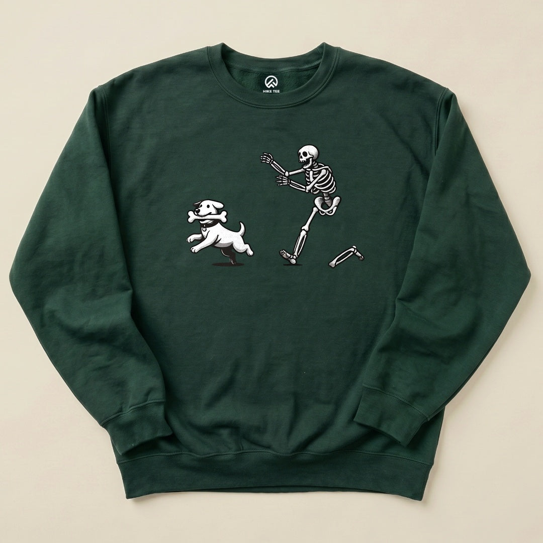 A dark green Skeleton and Dog Sweatshirt featuring a playful skeleton chasing a running white dog with a bone.