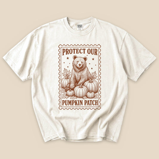 Ivory Protect Our Pumpkin Patch T-Shirt with a vintage bear guarding a pumpkin patch graphic