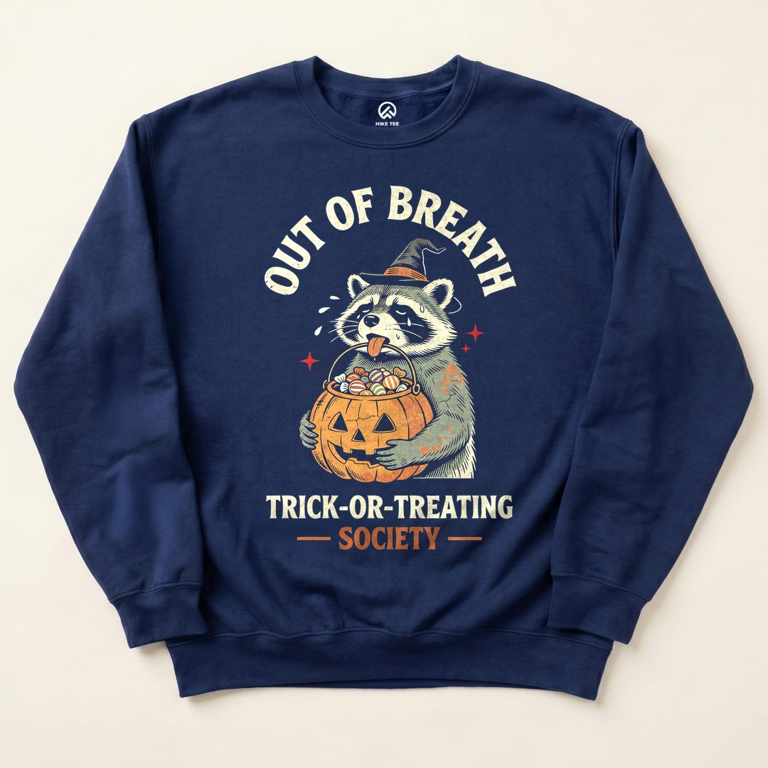 Navy Out of Breath Trick-or-Treating Society Sweatshirt with a tired raccoon holding a jack-o-lantern candy bucket graphic