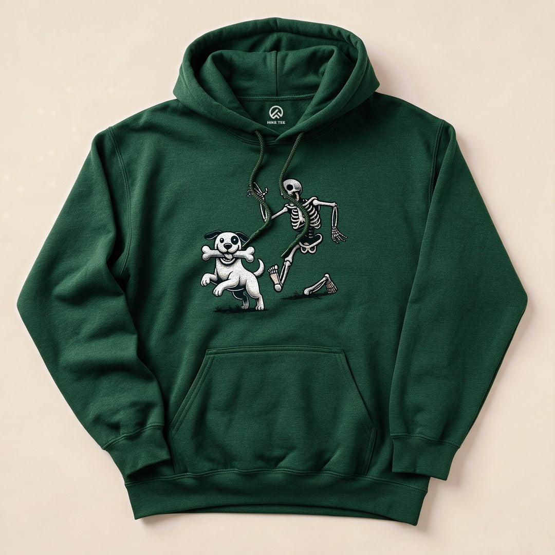 A Skeleton and Dog Halloween Hoodie featuring a playful skeleton running with a white dog holding a bone.
