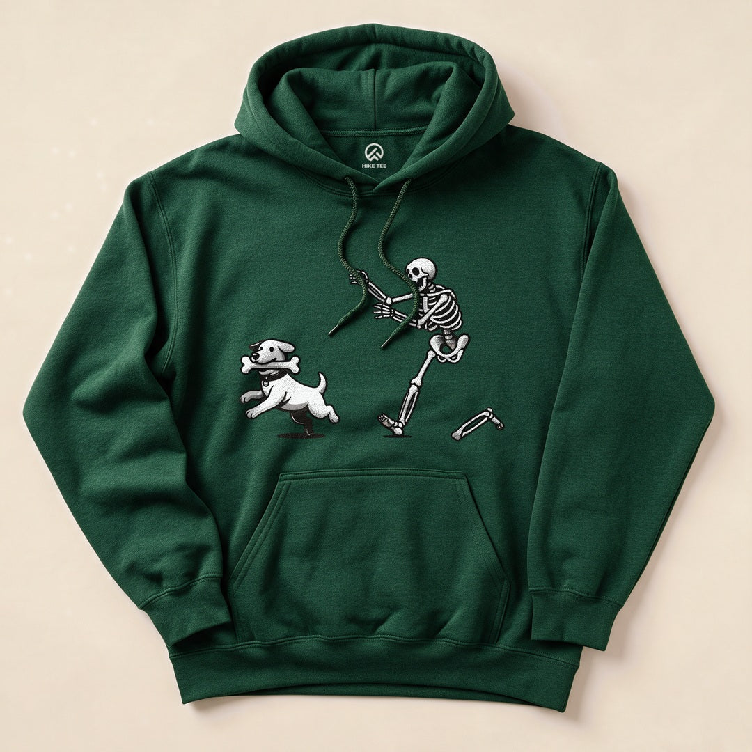 A green "Skeleton and Dog Hoodie" features a whimsical graphic of a skeleton running alongside a playful white dog with a bone.