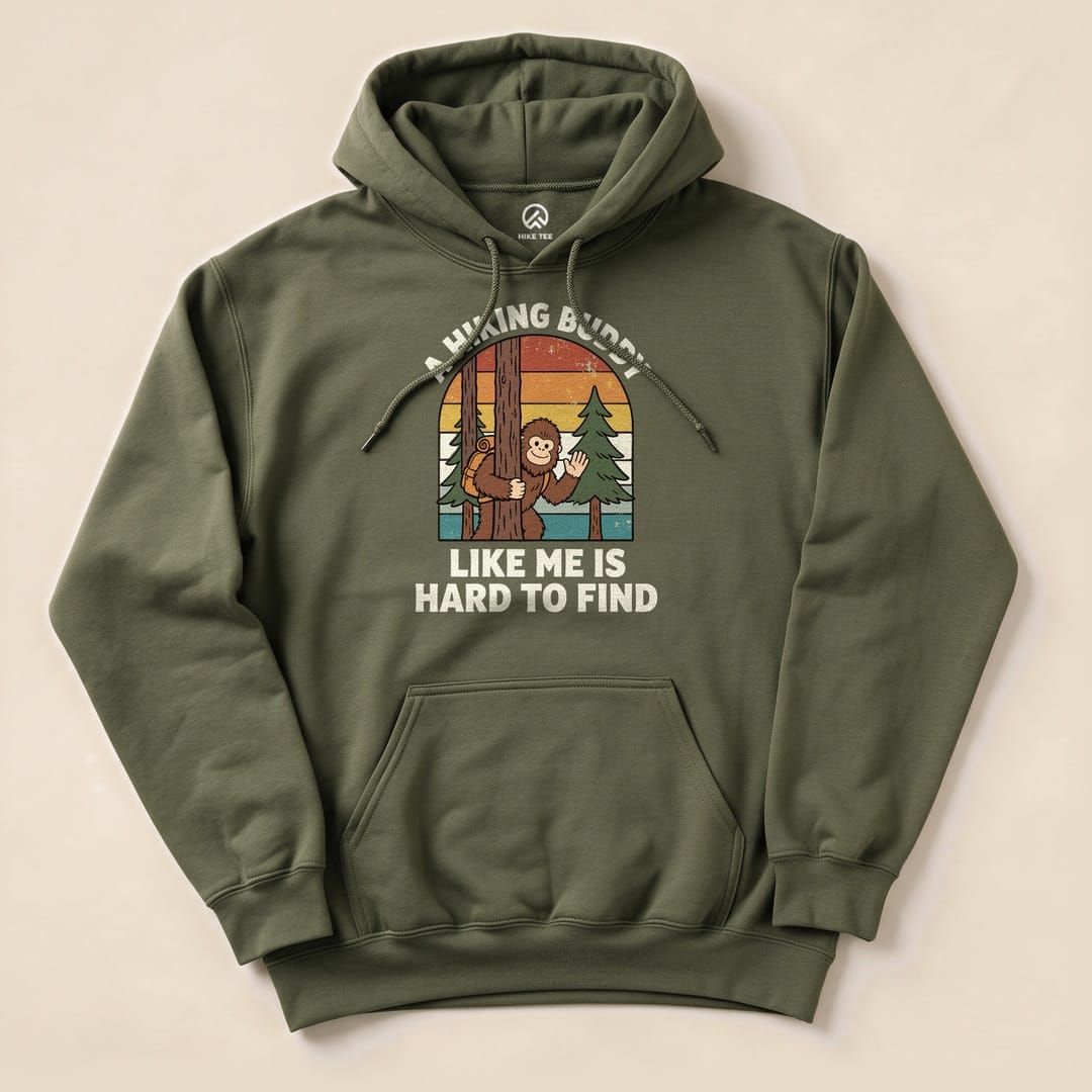 A graphic hoodie features a playful illustration of a monkey peeking from behind a tree with the text, "A Hiking Buddy Like Me Is Hard To Find.