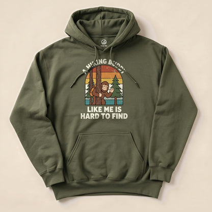 A graphic hoodie features a playful illustration of a monkey peeking from behind a tree with the text, "A Hiking Buddy Like Me Is Hard To Find.