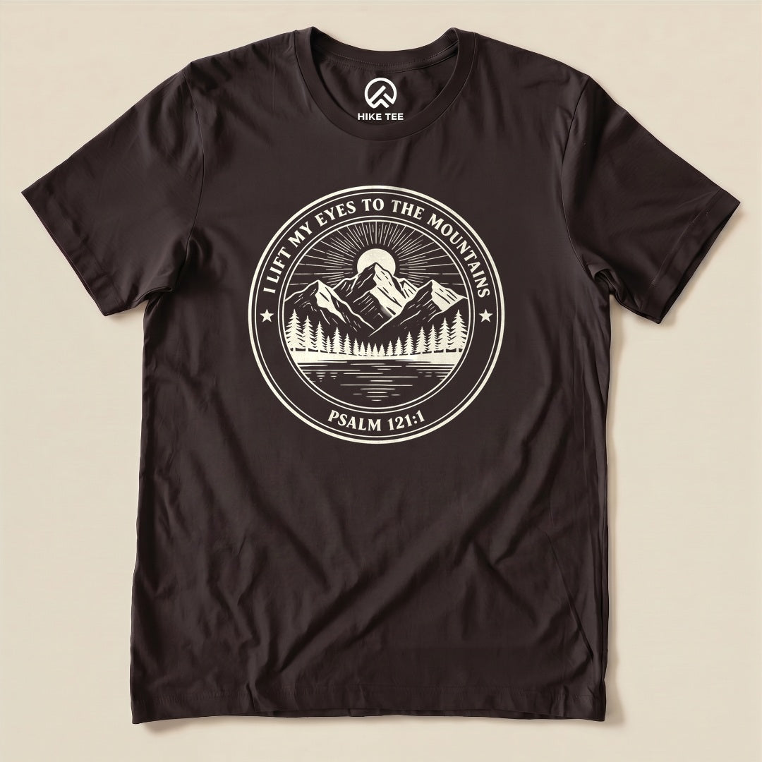Brown I Lift My Eyes to the Mountains Shirt with a mountain lake badge with Psalm 121:1 graphic